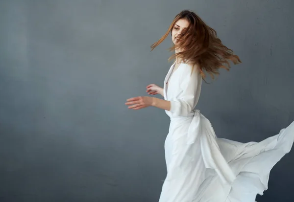 Mujer en vestido blanco glamour danza fondo gris — Foto de Stock