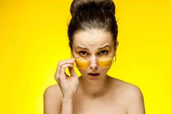 Pretty woman with bare shoulders yellow glasses emotions cropped view — Stock Photo, Image