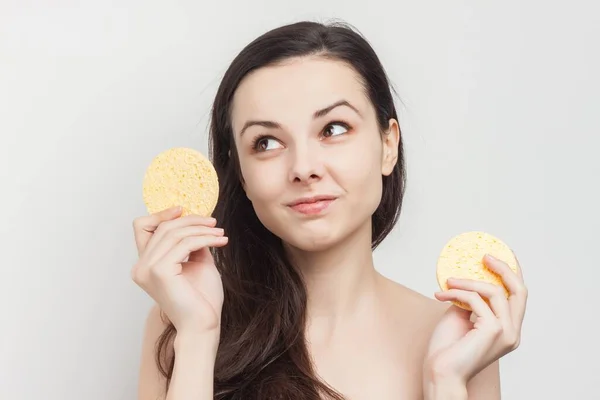 Morena com cabelo fluindo ombros nus esponja perto do rosto — Fotografia de Stock