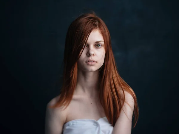 Sexy woman with red hair on a dark background and white towel portrait — Stock Photo, Image