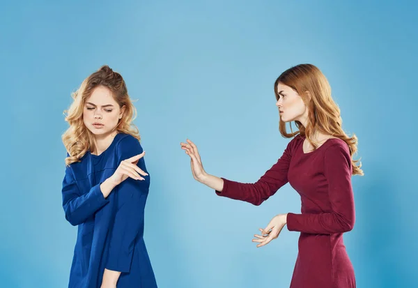 two women conflict quarrel communication lifestyle blue background