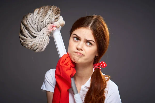 Cleaning lady with disgruntled expression mop in hand cleaning rooms — Stock Photo, Image