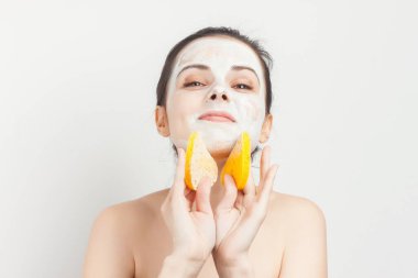 Güzel bir kadın çıplak omuzlarıyla cilt kremi kullanıyor.