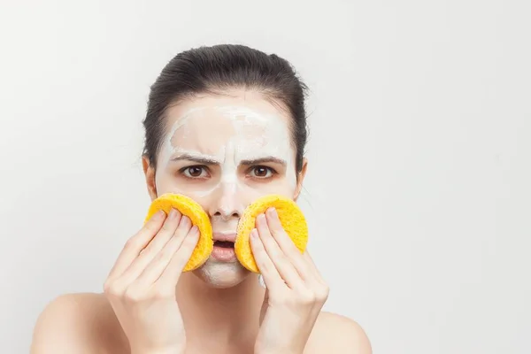 Emotional brunette with bare shoulders skin care cream cosmetics hygiene — Stock Photo, Image