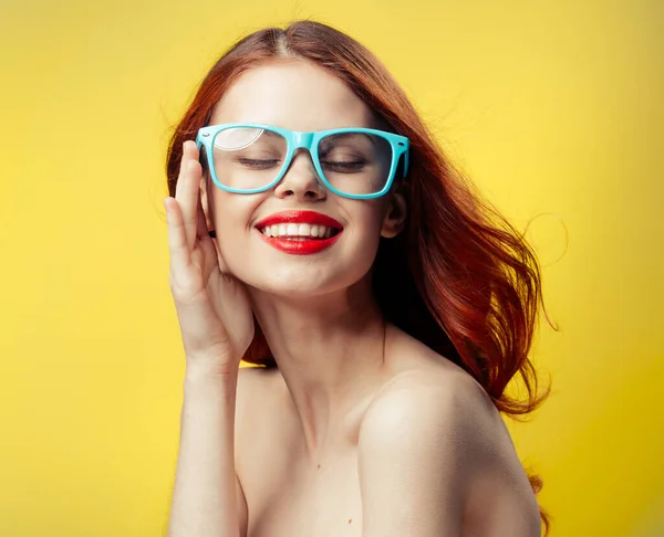 Attractive woman with bare shoulders red lips blue glasses close-up — Stock Photo, Image