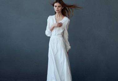 Beyaz elbiseli kadın dans performansı cazibesi gri arka plan 