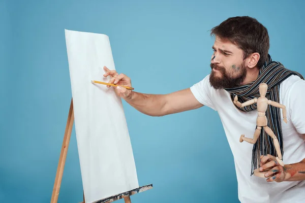 Male artist easel art drawing creativity blue background