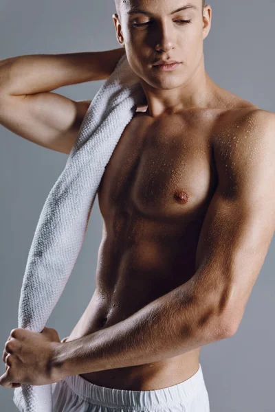 Muž s svalnaté tělo close-up cvičení ručník — Stock fotografie