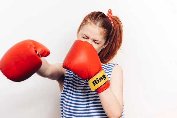 Woman in boxing gloves and in a striped T-shirt screaming aggression stress — Stock Photo, Image