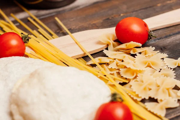 Pasta italiana su un tavolo di legno pomodorini ciliegini pranzo di cottura — Foto Stock