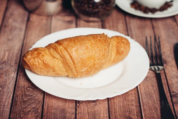 Croissant in a plate on the table kitchenware breakfast meal dessert — Stock Photo, Image