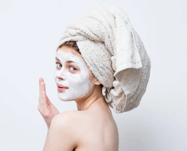 Happy woman with towel on head naked shoulders moisturizer on face mask — Stock Photo, Image