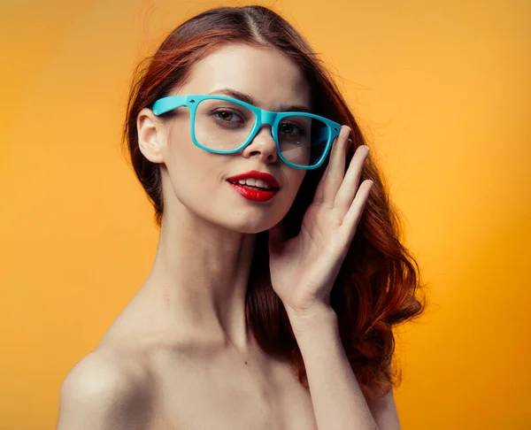 Attractive woman with bare shoulders blue glasses red hair cropped view — Stock Photo, Image