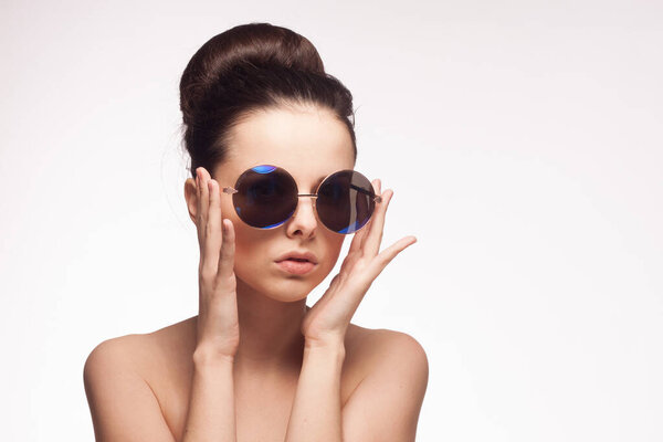 woman wearing sunglasses naked shoulders charm fashion light background