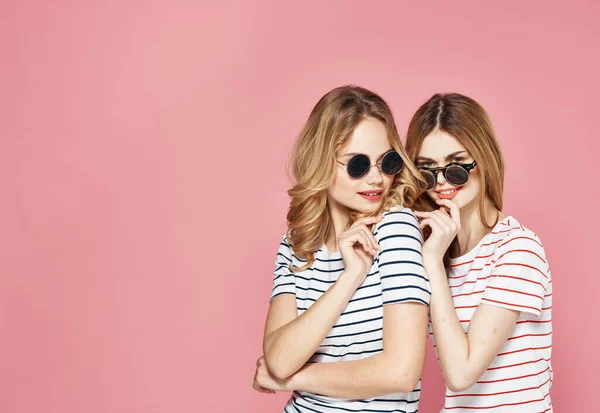 Two sisters stand side by side fashion studio lifestyle friendship