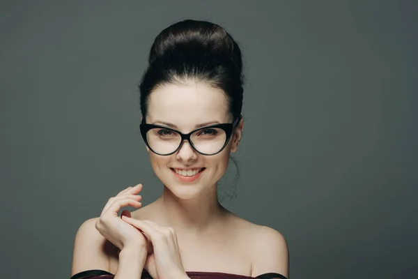 Pretty brunette with glasses naked shoulders attractive look dark background — Stock Photo, Image