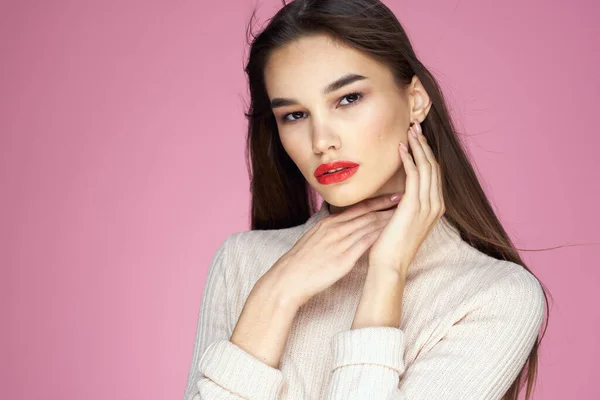 Morena bonita em uma camisola branca lábios vermelhos atraente olhar rosa fundo — Fotografia de Stock