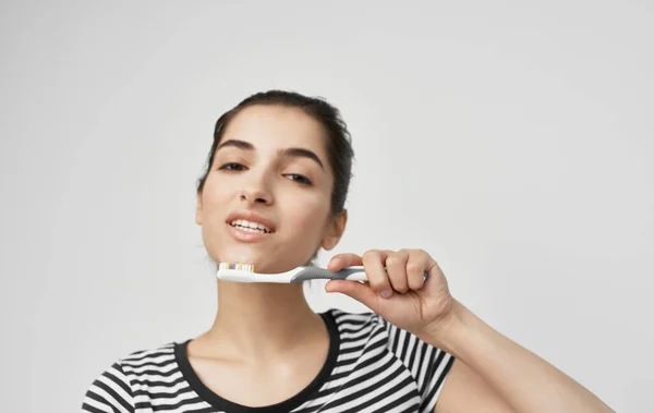 Mulher em t-shirt listrada escova de dentes higiene oral saúde — Fotografia de Stock