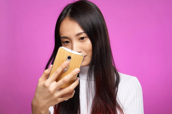 Pretty woman with a phone in her hands looking at the screen internet communication technology — Stock Photo, Image