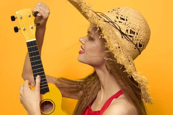 Woman holding Ukulele straw hat lifestyle Exotic yellow background — Stock Photo, Image