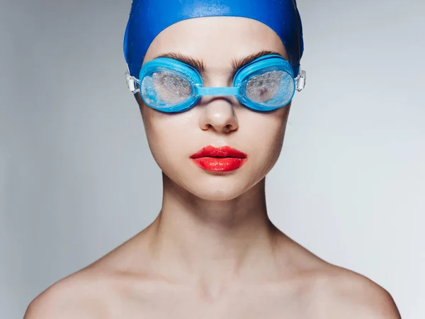 Sportswoman con labbra rosse in blu cuffia da nuoto e occhiali spalle nude vista ritagliata — Foto Stock