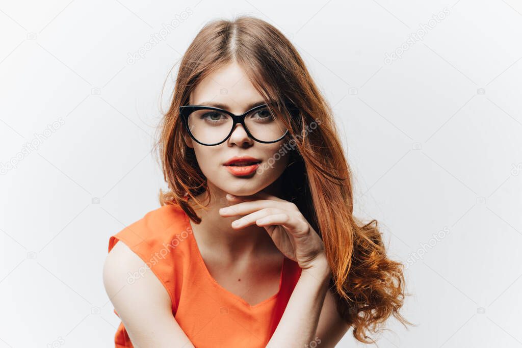female student in a sundress with a notebook and glasses on her face white background