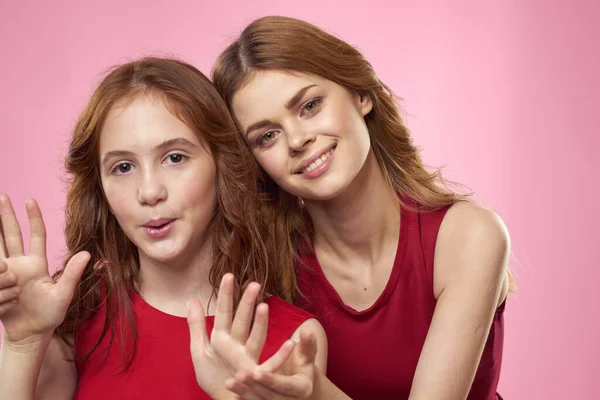 Mom and daughter fun communication family joy pink background cropped view — Stock Photo, Image