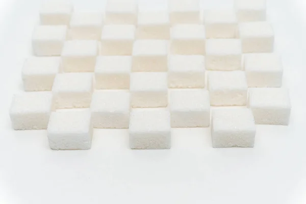 Sugar cubes staggered candy ingredient glucose light background — Stock Photo, Image
