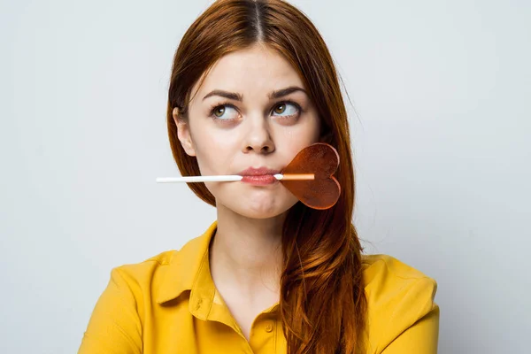 Cute red-haired woman with lollipop in her mouth glamor closeup — Stock Photo, Image