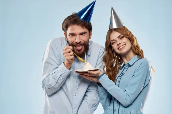 Birthday corporate young man and woman with cake on isolated background disco party