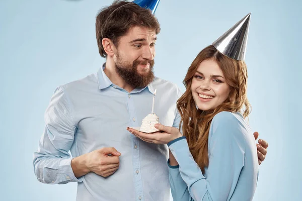 Birthday corporate young man and woman with cake on isolated background disco party