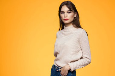 Sevimli esmer makyaj kırmızı dudaklar moda kıyafetler sarı arka plan