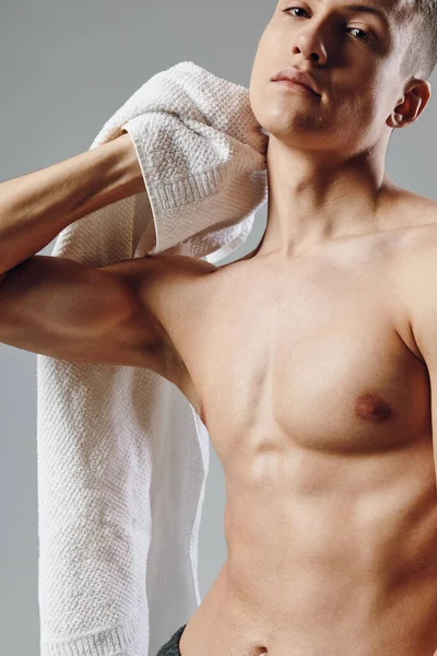 Retrato de um homem com um corpo muscular inflado, toalhas em suas mãos close-up — Fotografia de Stock