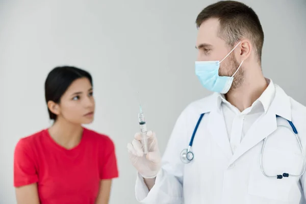 Пацієнт в лікарні дивиться на лікаря з шприцом в руці ін'єкція ковадла — стокове фото