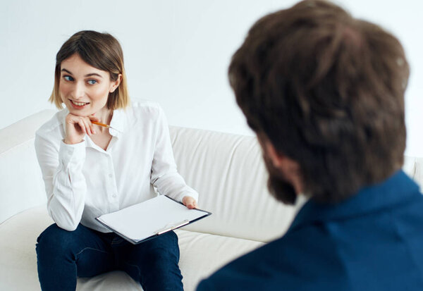 hiring vacancies woman with documents and a man in a suit are sitting on the couch