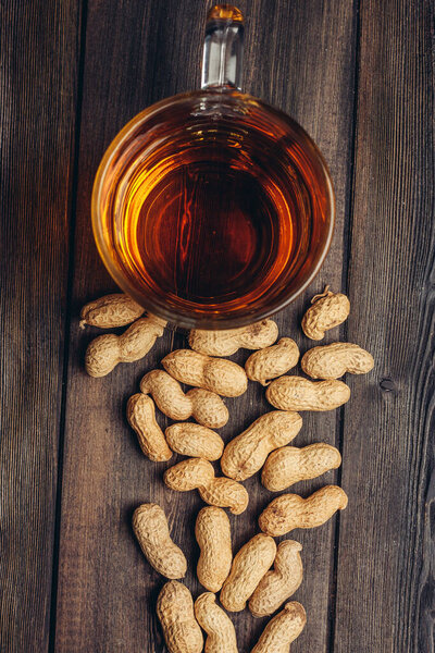 beer mug peanuts in shells on wooden background snack bar