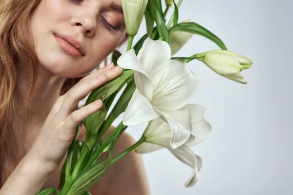 Retrato de uma mulher bonita com flores brancas em um fundo claro — Fotografia de Stock