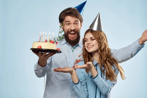 Emotional man with cake and pretty woman party disco blue background