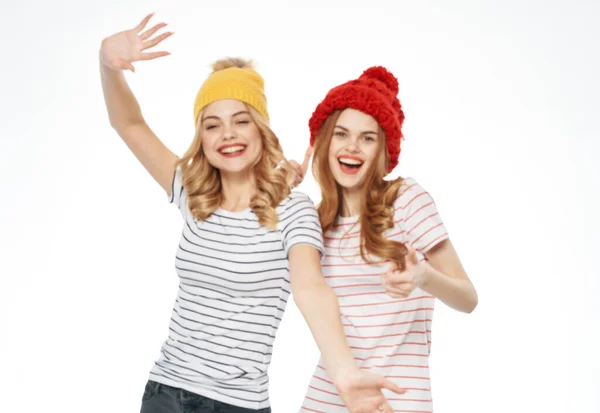 Дві жінки смугасті футболки барвисті капелюхи емоції весела студія моди радість — стокове фото