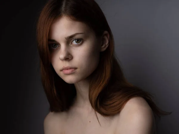 Rudowłosa kobieta z obnażonymi ramionami portret zbliżenie ciemne tło model — Zdjęcie stockowe