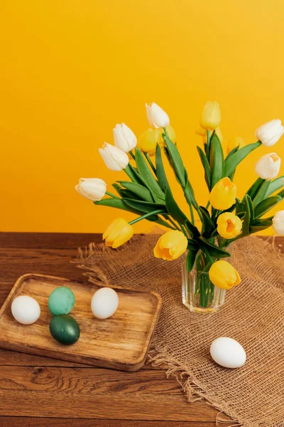 Vacances de printemps Pâques peint oeufs bouquet fleurs fond jaune — Photo