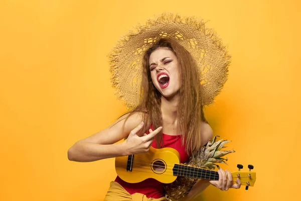 Woman holding Ukulele straw hat lifestyle Exotic yellow background — Stock Photo, Image