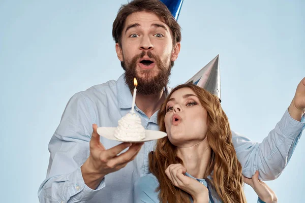Birthday corporate young man and woman with cake on isolated background disco party