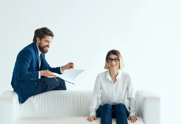 business man and woman team of professionals white sofa communication