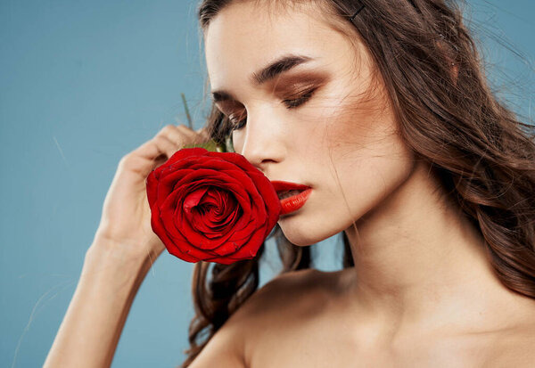 Red rose sexy woman naked shoulders makeup blue background