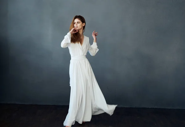 Mujer sobre un fondo gris en un modelo de baile vestido blanco en pleno crecimiento — Foto de Stock