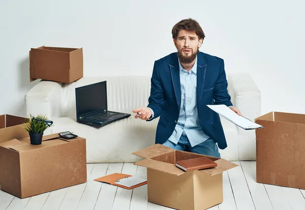 Business man unpacking boxes with things for an official Professional