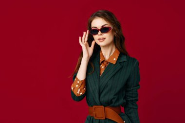 woman wearing sunglasses suit jacket fashion red background