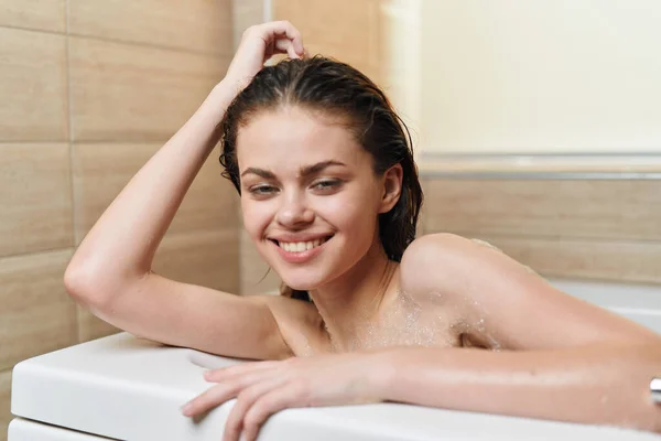 Cheerful woman lies in the bathroom hygiene clean skin relaxation — Foto Stock