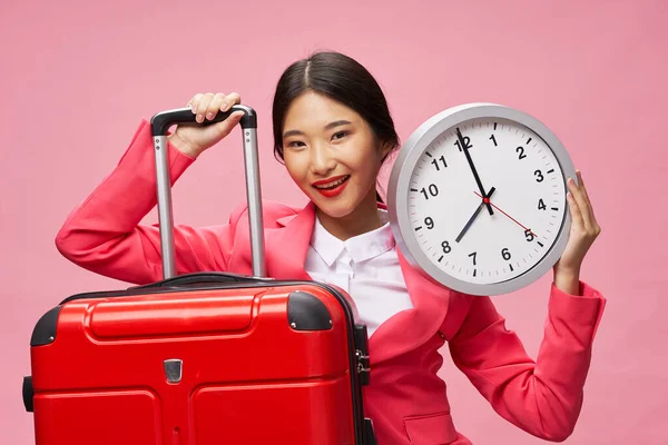 cheerful asian woman suitcase on vacation watch in hand travel